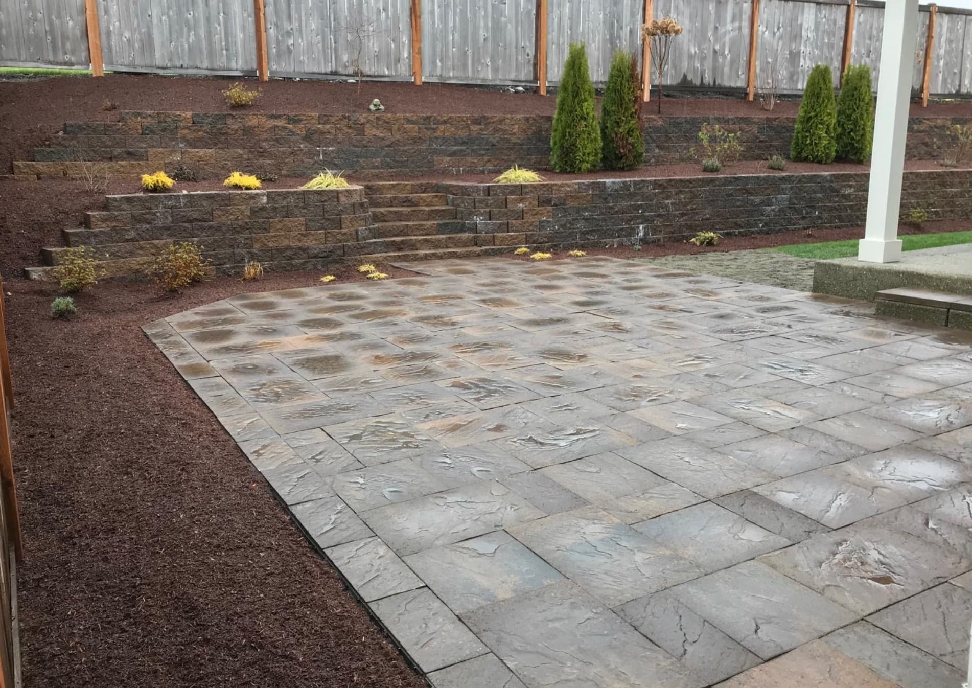 Completed paver patio with retaining and planting details in Tacoma WA